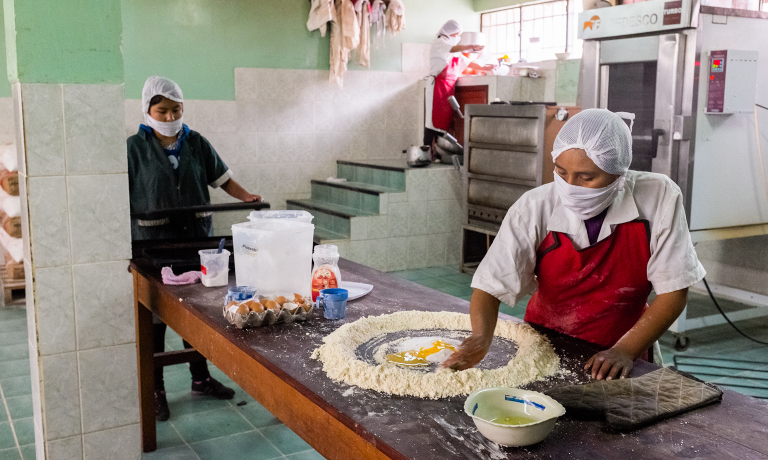 Women work in a kitchen in Bolivia