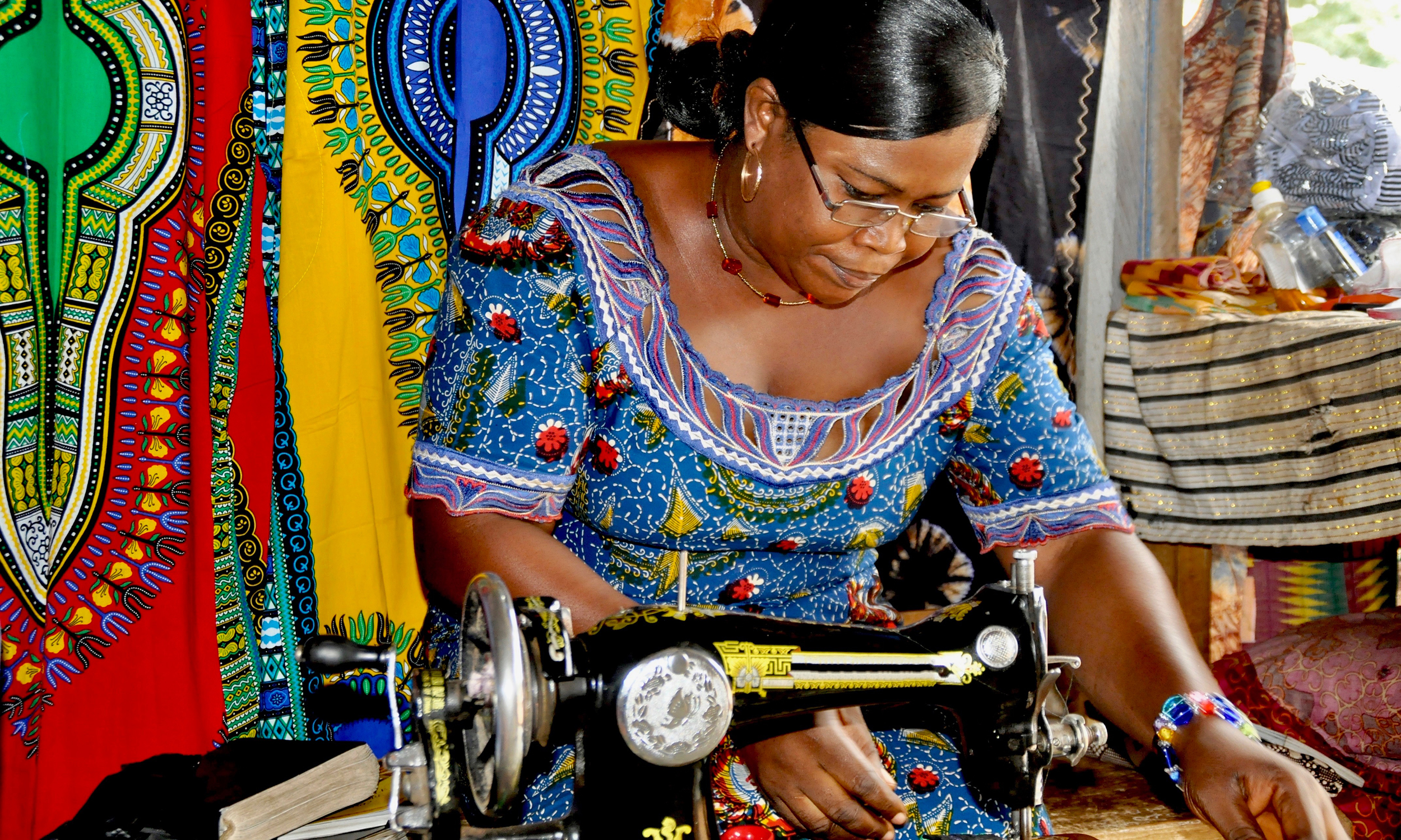 A seamstress in Ghana at her sewing machine
