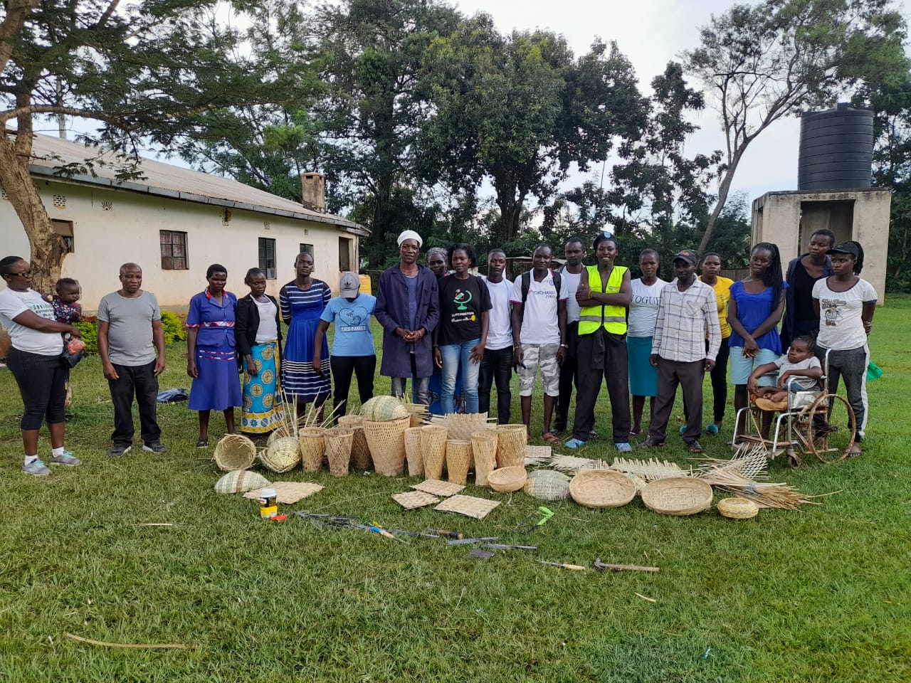 A large group of Kenyan bamboo craftworkers and farmers stand outside