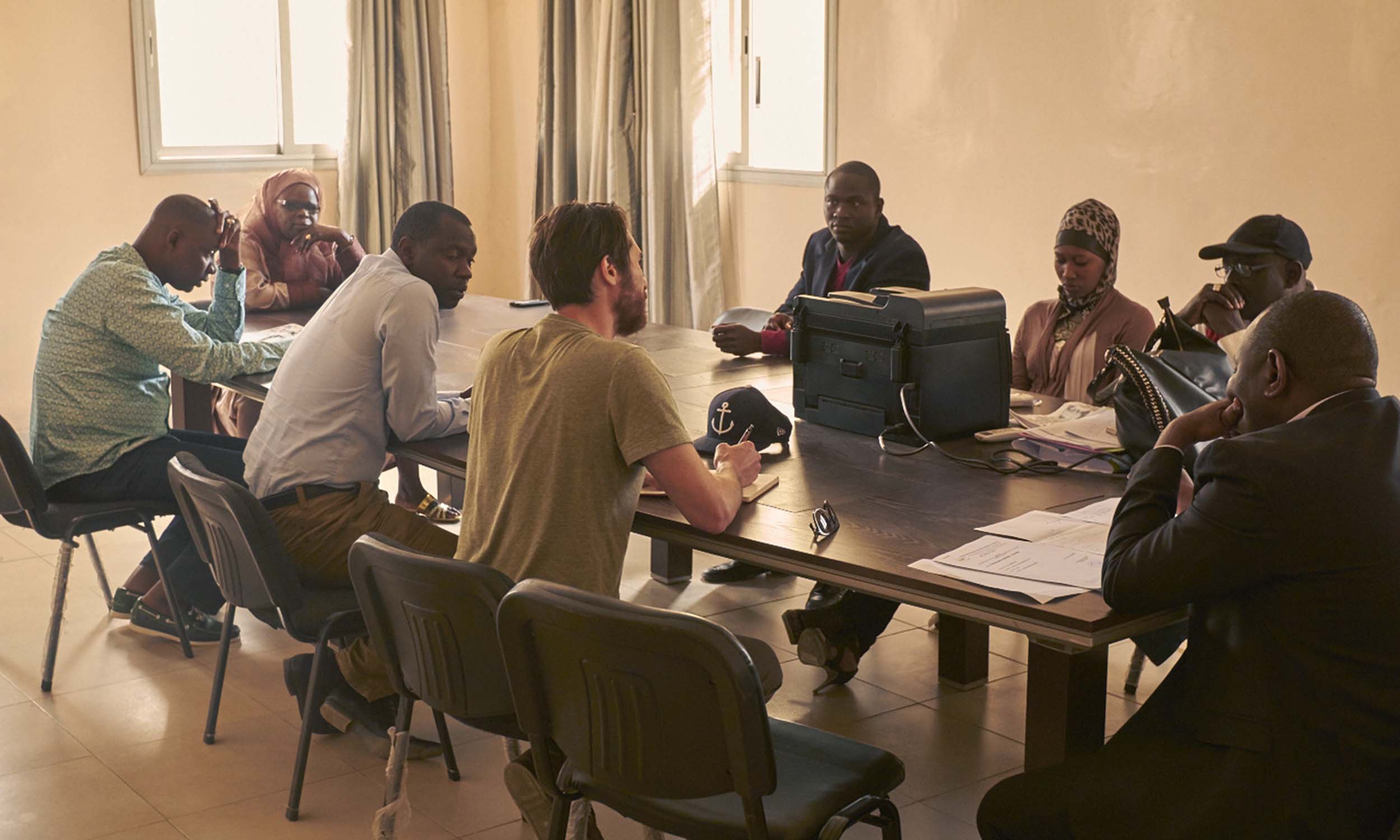 a group of people in discussion in a board room