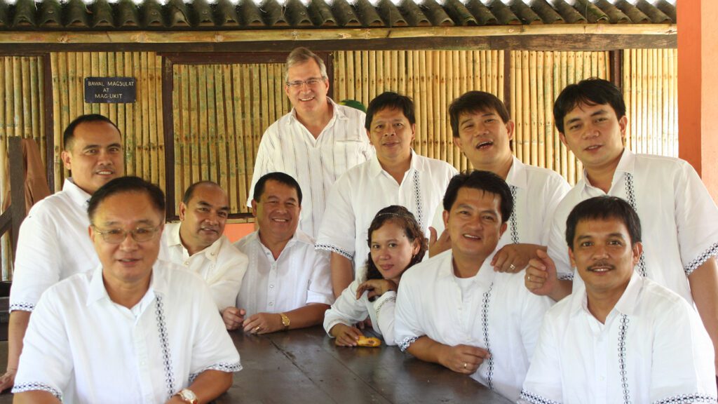 A group of smiling municipal workers in the Philippines